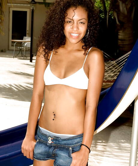 Hot teen Gia Jones in sexy shorts revealing tiny tits and spreading her legs near the pool